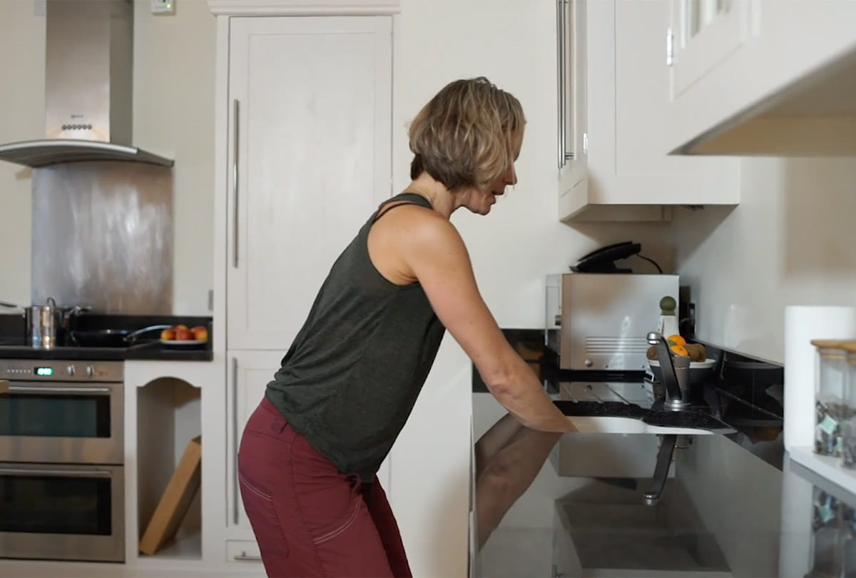 At a Sink Leaning Forwards